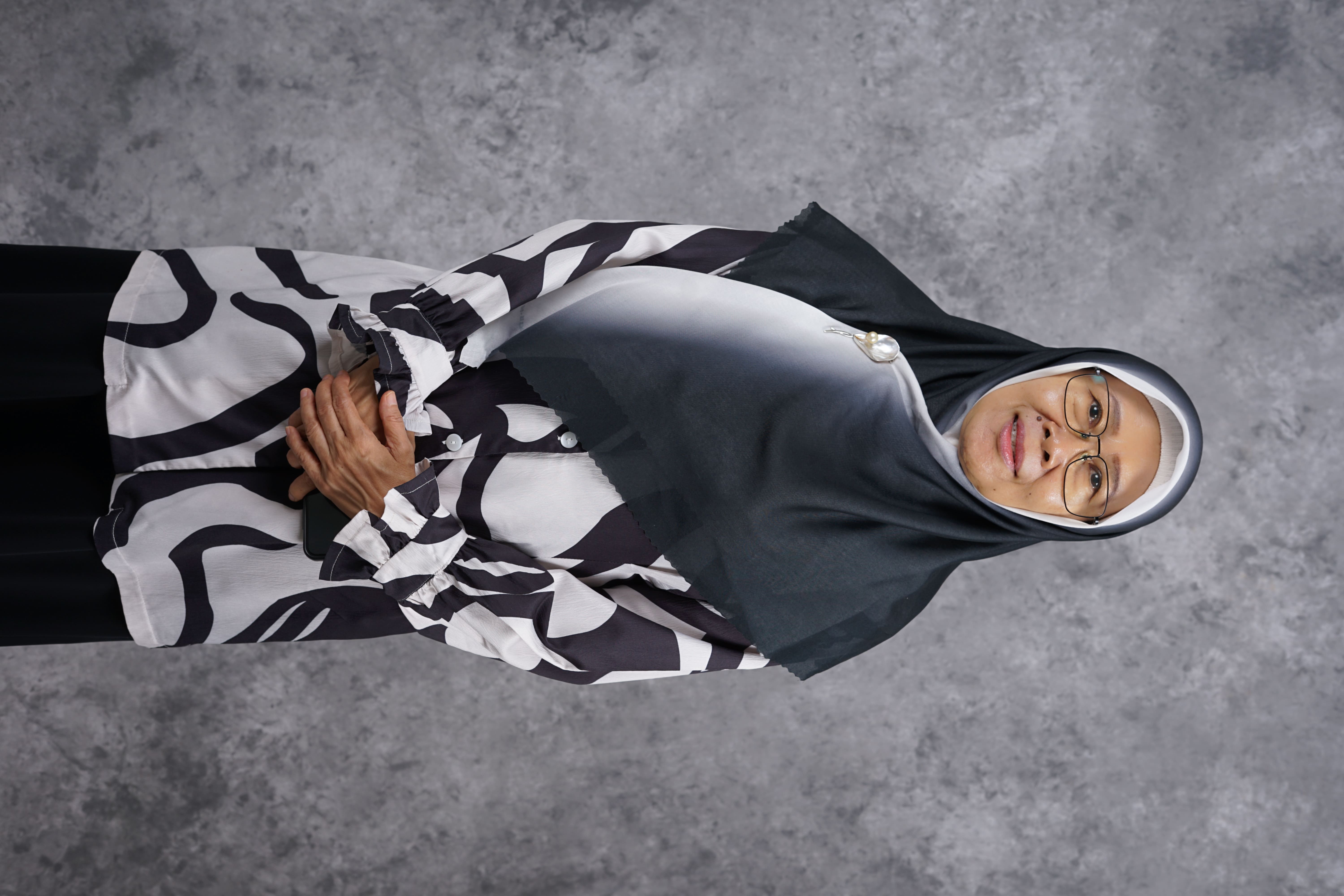 Dr. Hj. Hartini Haritani, M.Pd